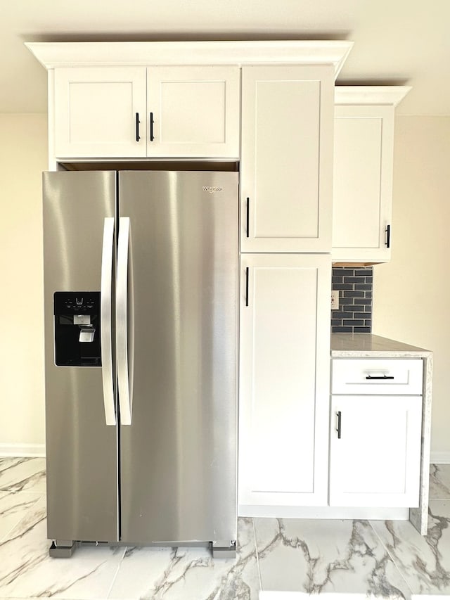 kitchen featuring light tile floors, white cabinetry, and stainless steel refrigerator with ice dispenser