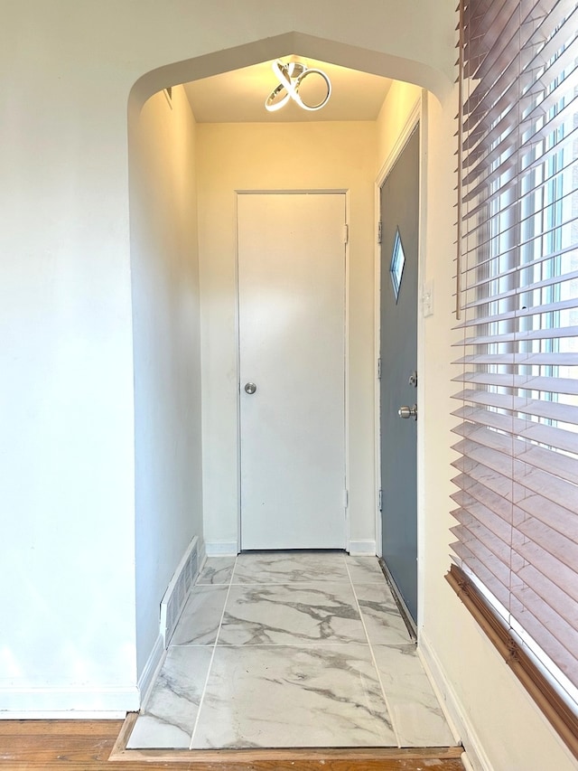 doorway with light tile flooring