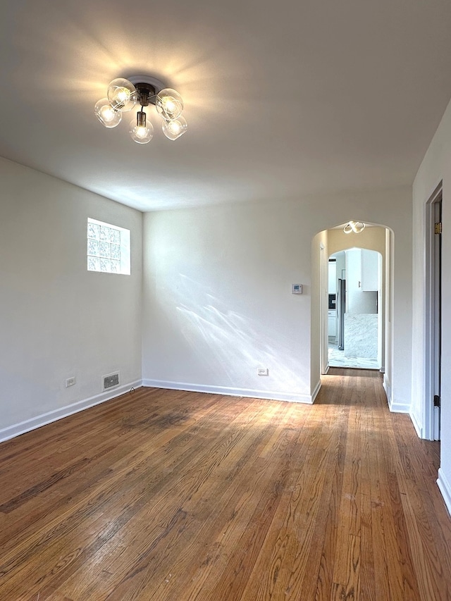 spare room with dark wood-type flooring