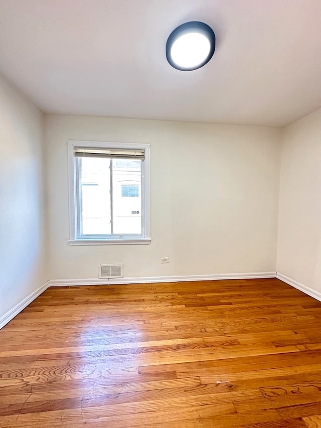 empty room with light hardwood / wood-style floors