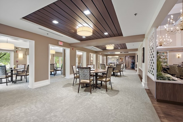 dining room featuring wooden ceiling, a chandelier, and carpet