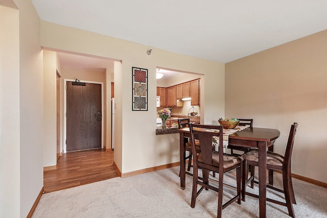 dining space featuring light wood-type flooring