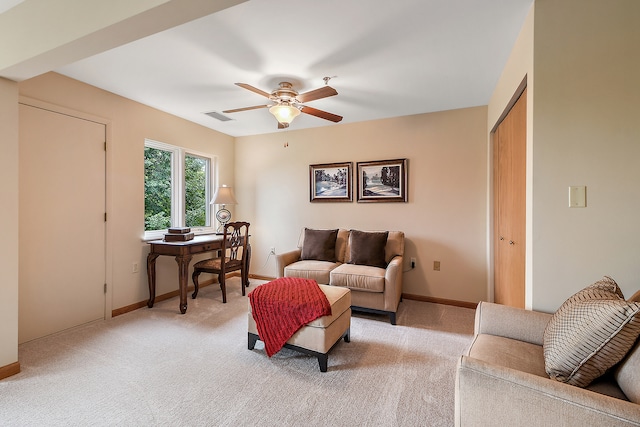 carpeted living room featuring ceiling fan