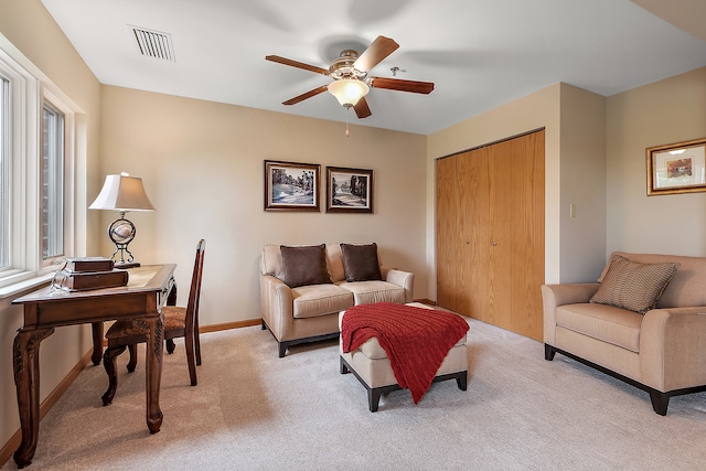 living room with ceiling fan and light carpet