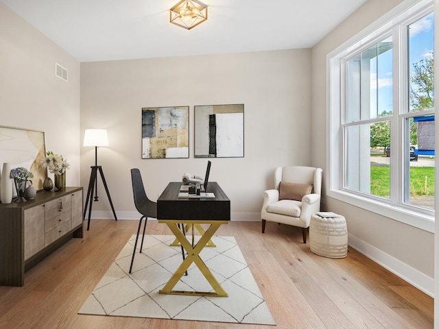 home office with a healthy amount of sunlight and light wood-type flooring