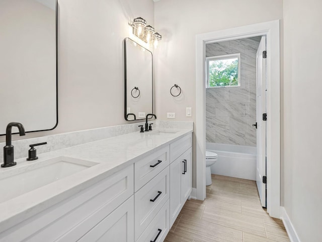 full bathroom with vanity, toilet, and tiled shower / bath combo