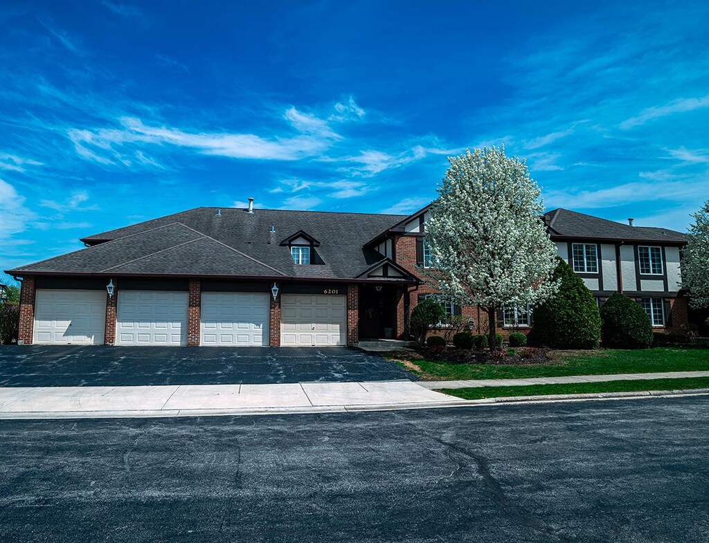 6201 Willowhill Rd Unit A, Willowbrook, IL 60527 - view of front facade featuring aphalt driveway, an attached garage, and brick siding