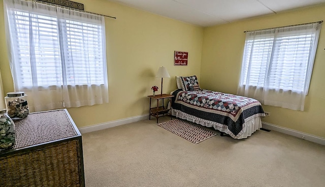 carpeted bedroom featuring baseboards
