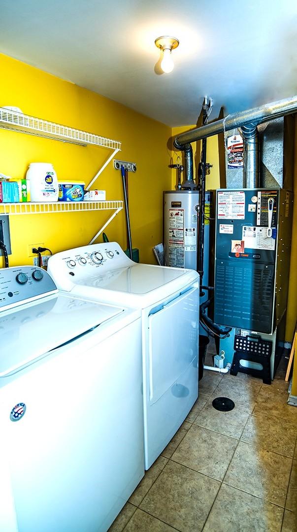 laundry room with separate washer and dryer, tile patterned flooring, and laundry area