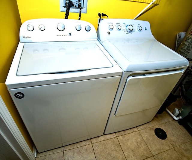 laundry room featuring light tile patterned floors, washing machine and dryer, and laundry area