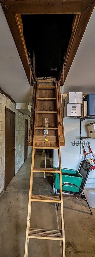staircase with concrete block wall and unfinished concrete floors