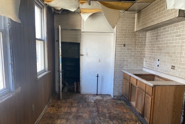 kitchen featuring brick wall