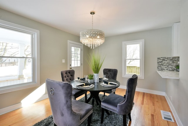 dining room featuring an inviting chandelier and light wood-type flooring