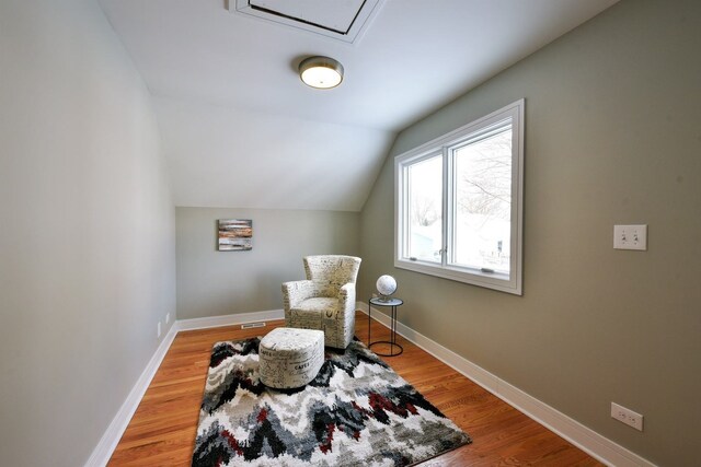 living area featuring light hardwood / wood-style flooring and lofted ceiling