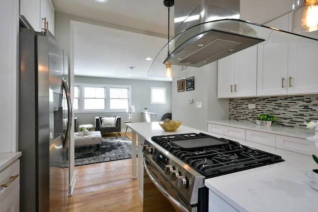 kitchen featuring stainless steel appliances, white cabinets, and island range hood