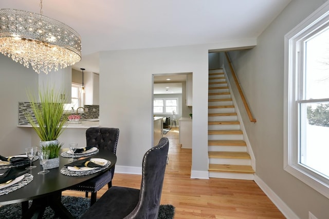 office with a notable chandelier, light hardwood / wood-style flooring, and sink