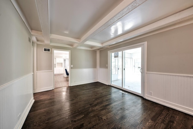 unfurnished room featuring dark hardwood / wood-style flooring and beam ceiling