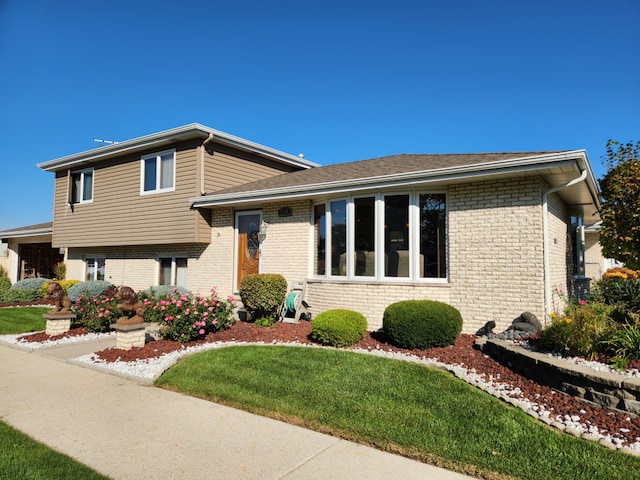 tri-level home with a front yard