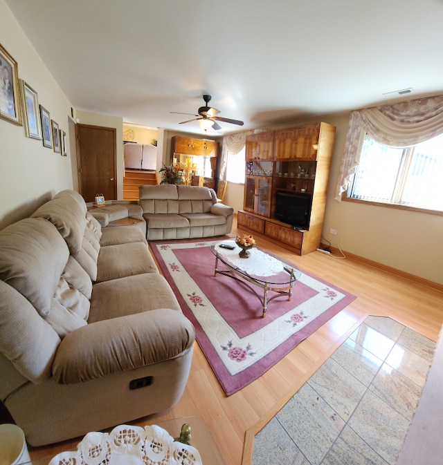 living room featuring ceiling fan and light wood-type flooring