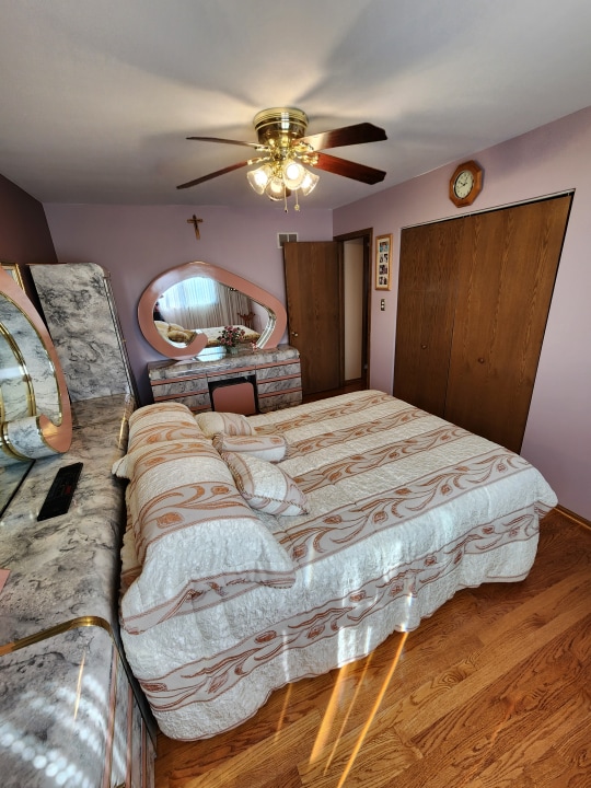 bedroom featuring ceiling fan and hardwood / wood-style floors