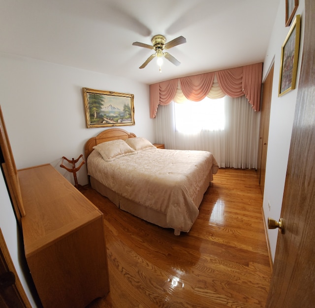 bedroom featuring ceiling fan and light hardwood / wood-style floors