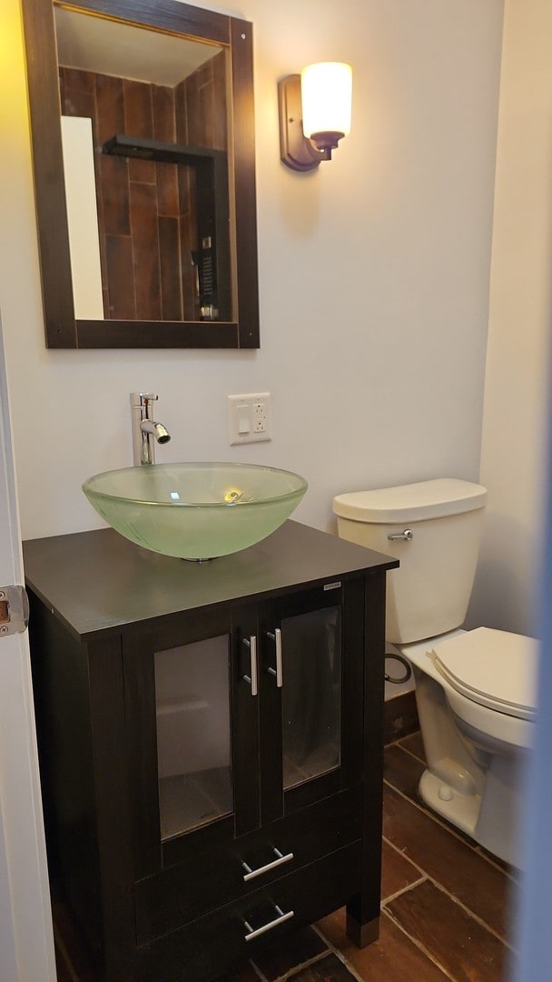 bathroom featuring toilet and vanity