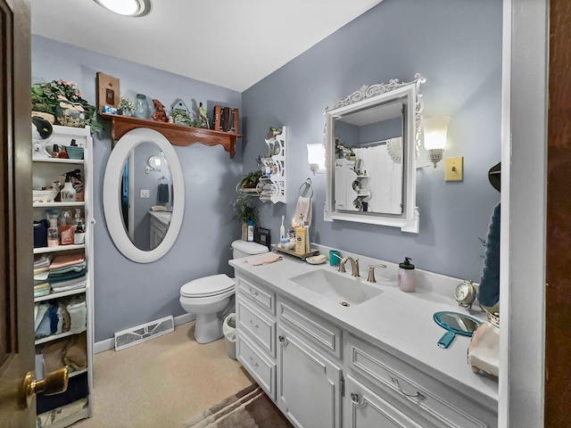 bathroom featuring toilet and vanity