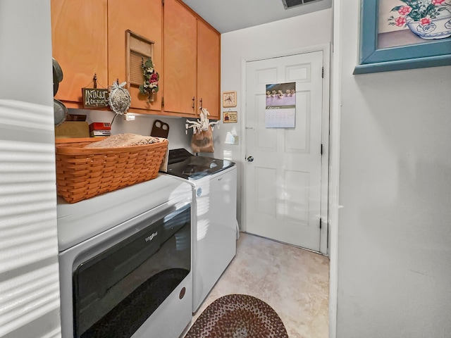 laundry room with cabinets, separate washer and dryer, and light tile floors