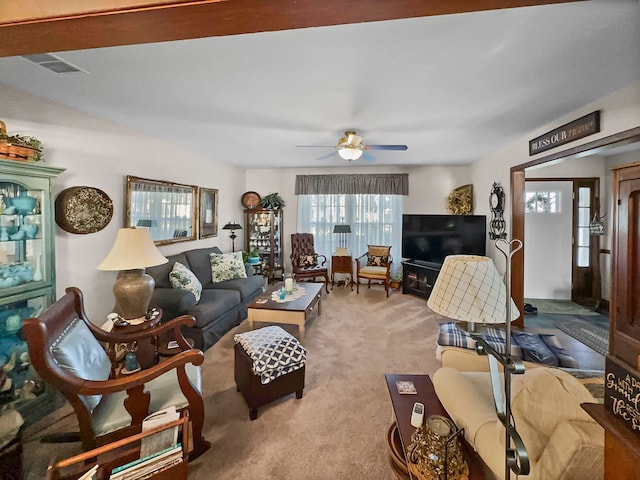 carpeted living room with ceiling fan