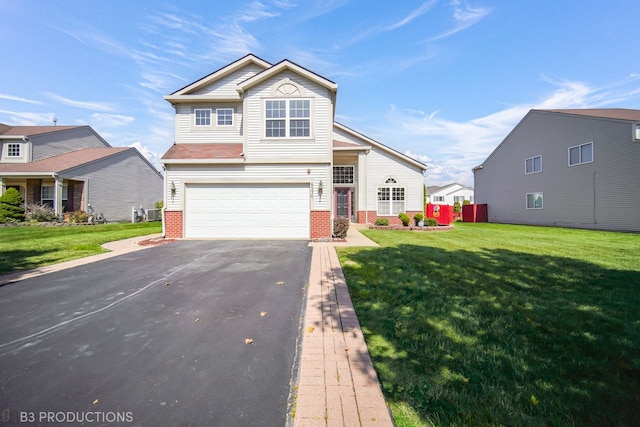 view of front of property with a front yard and a garage