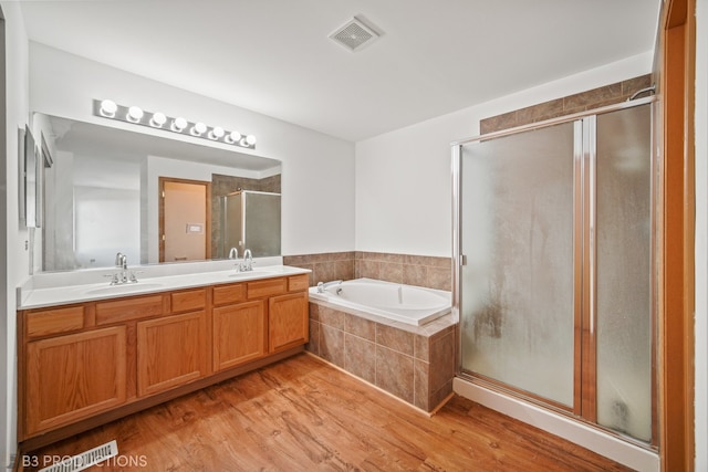 bathroom featuring vanity, hardwood / wood-style flooring, and independent shower and bath