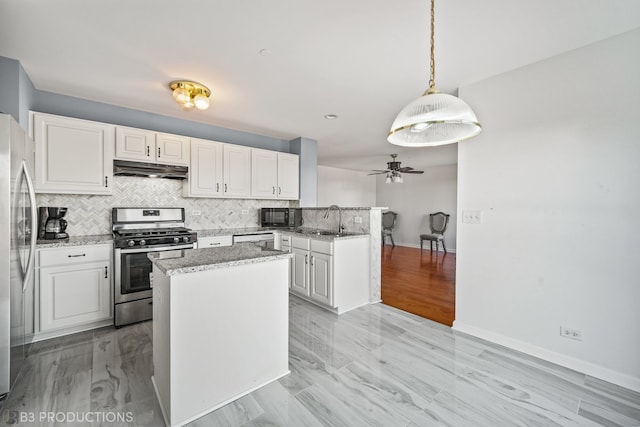 kitchen with sink, white cabinetry, ceiling fan, stainless steel appliances, and pendant lighting