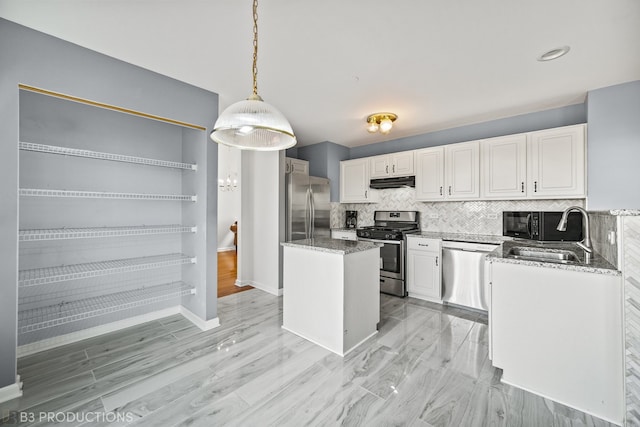 kitchen featuring sink, a kitchen island, hanging light fixtures, stainless steel appliances, and white cabinets