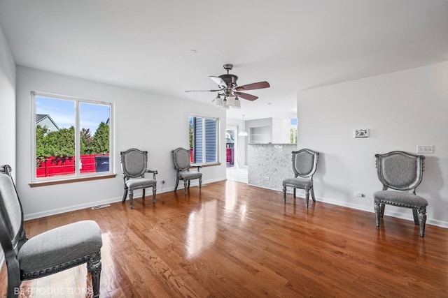 sitting room featuring ceiling fan and wood-type flooring