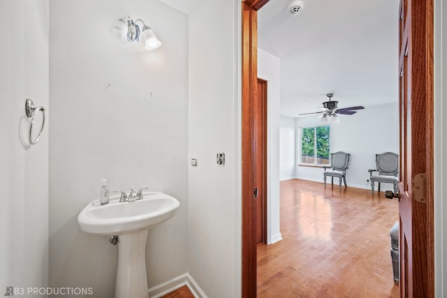 bathroom with hardwood / wood-style flooring and ceiling fan