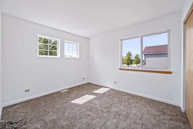 carpeted empty room with a wealth of natural light