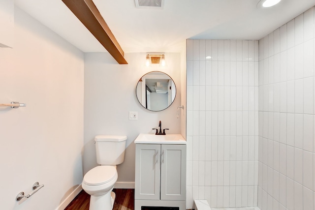 bathroom featuring toilet, vanity, and wood-type flooring