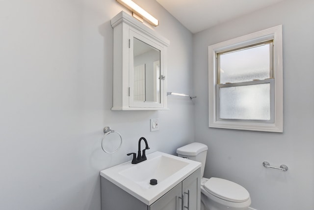 bathroom featuring toilet and vanity