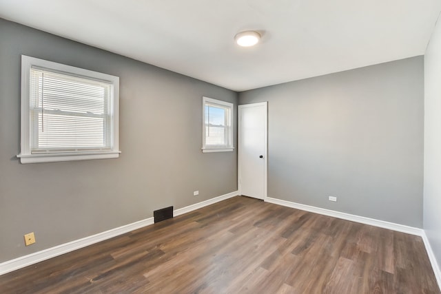 spare room featuring dark hardwood / wood-style floors