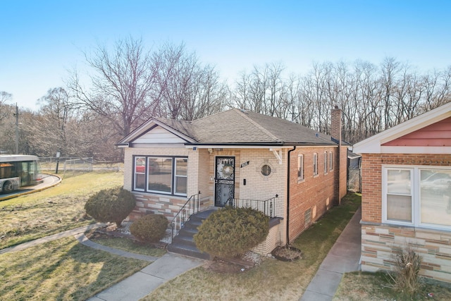 bungalow-style house featuring a front yard