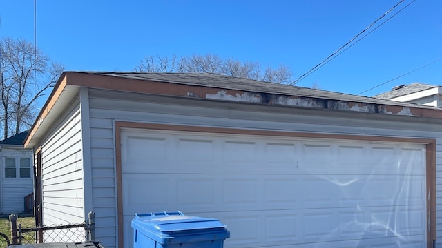 detached garage featuring fence