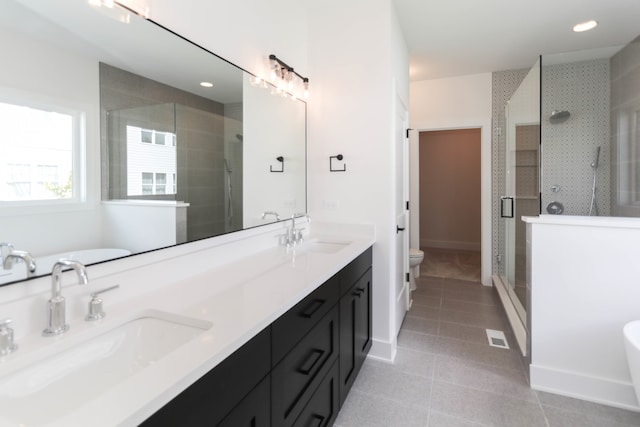 full bathroom with shower with separate bathtub, toilet, dual bowl vanity, and tile flooring