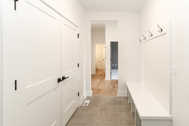 mudroom featuring light tile flooring