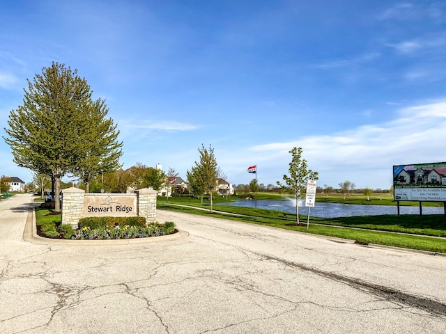 exterior space featuring a water view and a yard