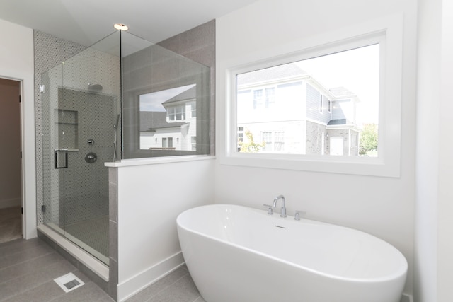 bathroom with tile floors and separate shower and tub