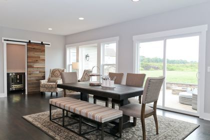 dining space featuring a barn door and dark hardwood / wood-style floors