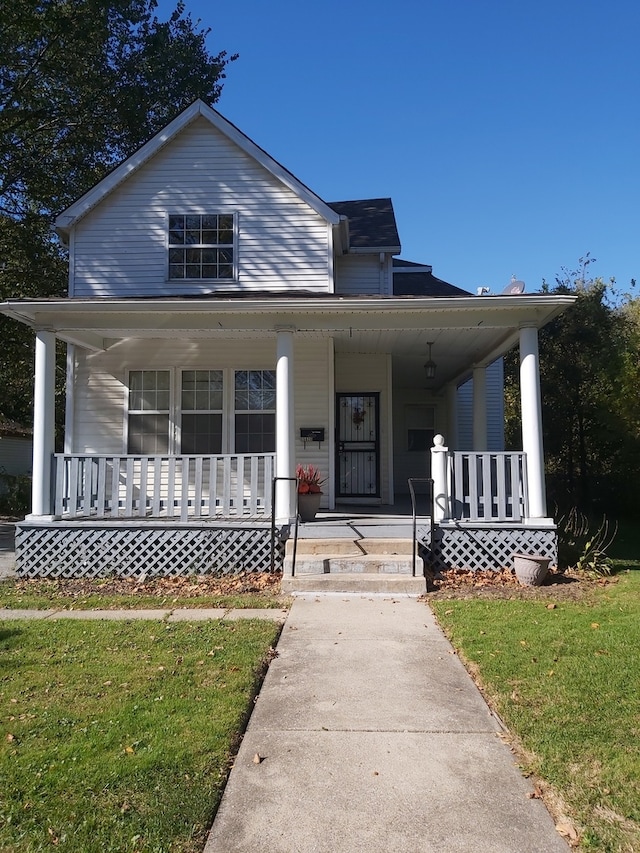 view of front of house featuring covered porch and a front lawn