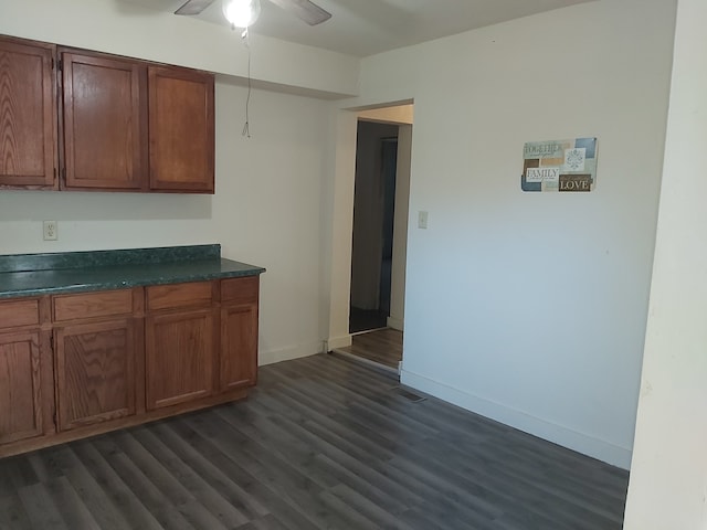 kitchen with ceiling fan and dark hardwood / wood-style flooring