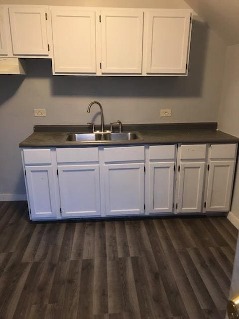 kitchen with sink, white cabinets, and dark hardwood / wood-style flooring