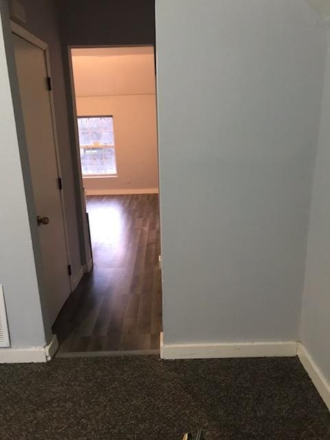 corridor featuring dark wood-type flooring